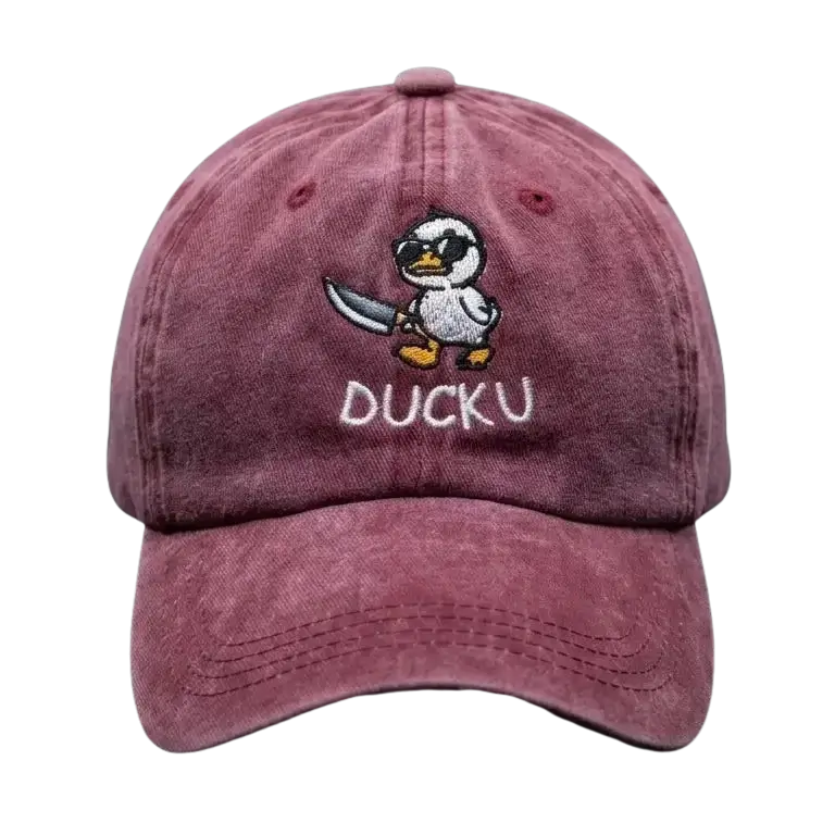 A Burghandy baseball cap featuring an embroidered cartoon duck character holding a sword and the text 'DUCKU' on the front, set against a dark textured background.