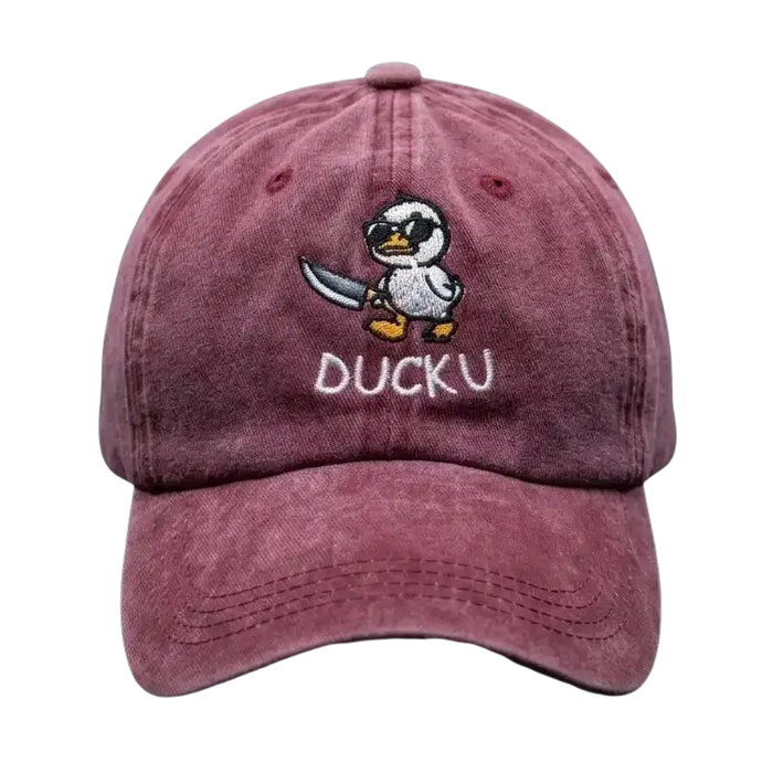 A Burghandy baseball cap featuring an embroidered cartoon duck character holding a sword and the text 'DUCKU' on the front, set against a dark textured background.